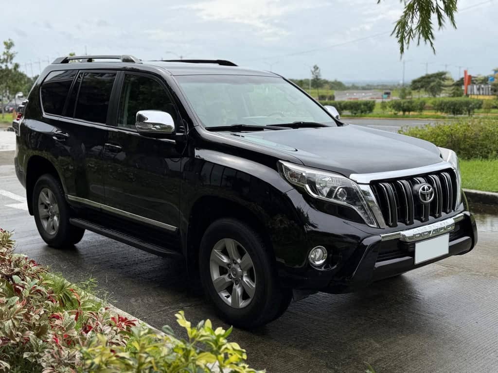 One-way car rental in Rwanda with a vehicle on a scenic road near Lake Kivu