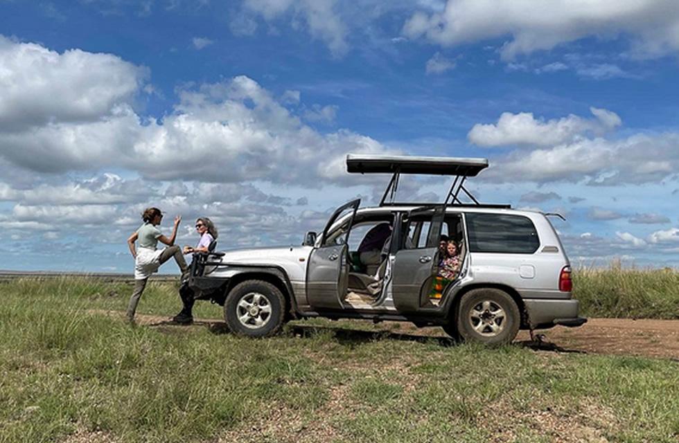 Family preparing for a road trip with a rental car in Rwanda